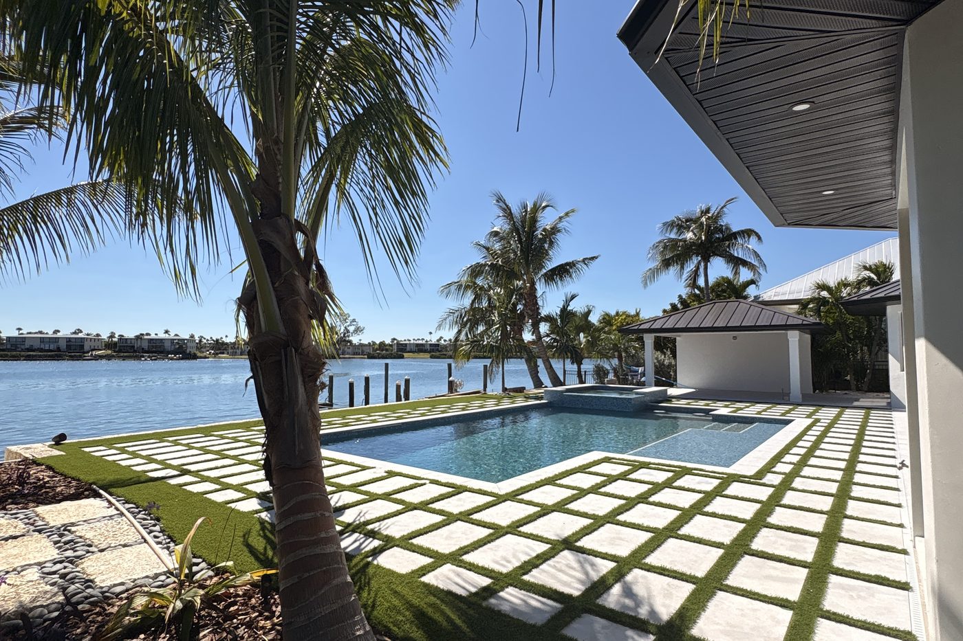 Stepping stone path with pebble surround and tropical plantings