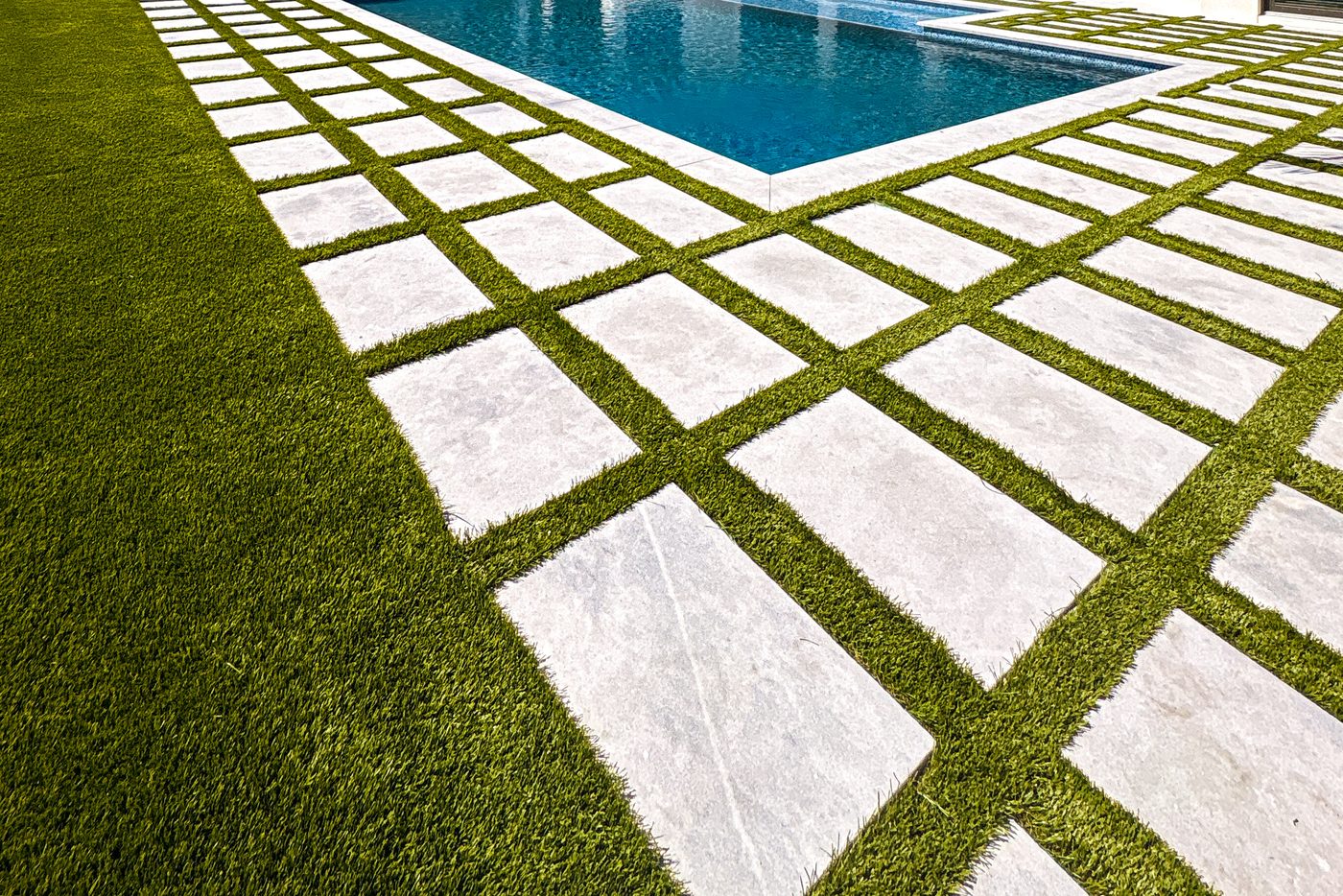 Artificial turf grid paver installation with palm tree